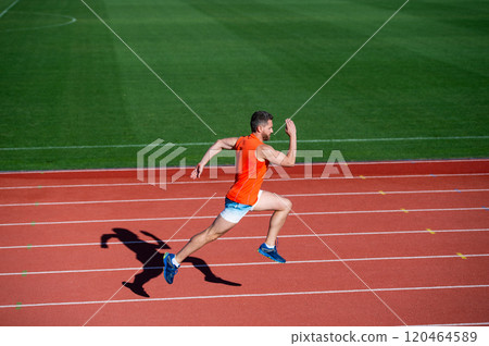 athletic muscular man running on racetrack at outdoor stadium, finish athletic muscular man running on racetrack at outdoor stadium, finish 120464589