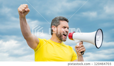 man in yellow shirt scream in megaphone on sky background man in yellow shirt scream in megaphone on sky background 120464703