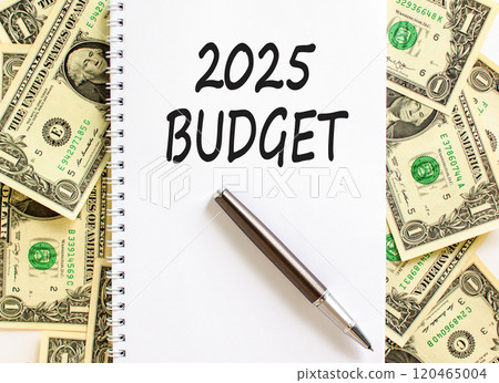 Planning 2025 budget new year symbol. Concept words 2025 Budget on beautiful white note. Beautiful background from dollar bills. Black pen. Business 2025 budget new year concept. Copy space. 120465004