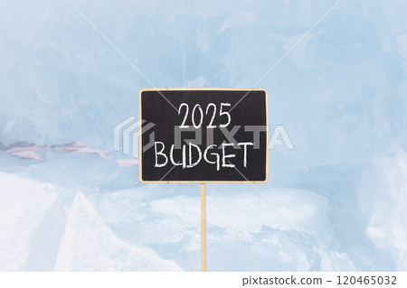 Planning 2025 budget new year symbol. Concept words 2025 Budget on beautiful yellow chalk blackboard. Beautiful Baikal lake blue ice background. Business 2025 budget new year concept. Copy space. Planning 2025 budget new year symbol. Concept words 2025 Budget on beautiful yellow chalk blackboard. Beautiful Baikal lake blue ice background. Business 2025 budget new year concept. Copy space. 120465032