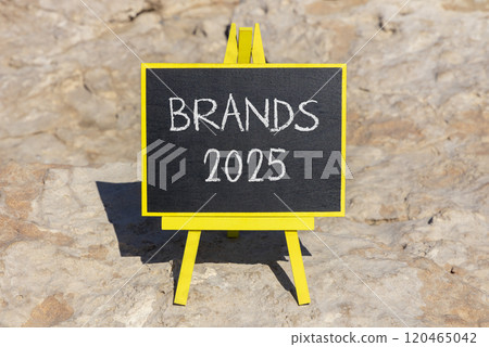 Planning brands 2025 new year symbol. Concept words Brands 2025 on beautiful yellow chalk blackboard. Beautiful stone beach background. Business brands 2025 new year concept. Copy space. Planning brands 2025 new year symbol. Concept words Brands 2025 on beautiful yellow chalk blackboard. Beautiful stone beach background. Business brands 2025 new year concept. Copy space. 120465042