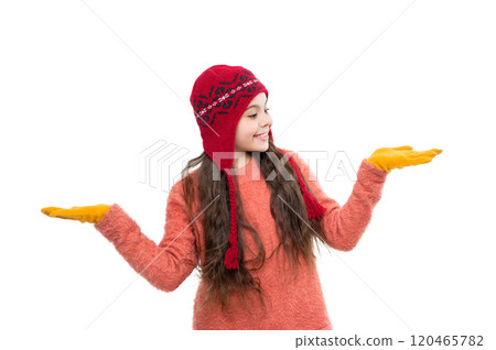 Girl with winter hat isolated on white. Winter fashion style trend. Teen girl in hat enjoying childhood. Girl wearing trendy outfit with knitted beanie hat. Presenting product 120465782