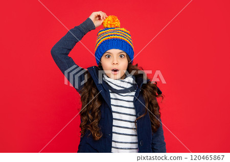 shocked teen girl on red background. portrait of child wearing warm clothes. 120465867