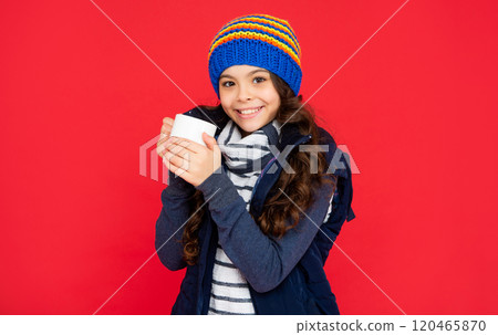 drinking cocoa and milk. smiling kid in puffer waistcoat and hat. teen girl drink warm tea 120465870