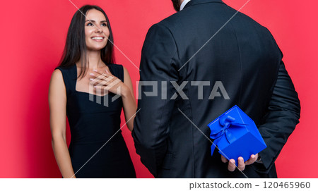 Happy Valentines day. Couple in love isolated on red. Romantic proposal with gift. Present. Dreamy proposal. Man making proposal to woman. Man give present gift box for Valentines day to woman Happy Valentines day. Couple in love isolated on red. Romantic proposal with gift. Present. Dreamy proposal. Man making proposal to woman. Man give present gift box for Valentines day to woman 120465960