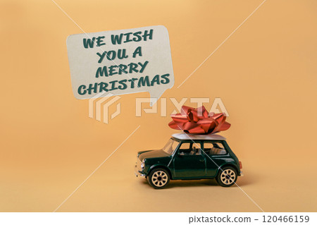 Green car with a red bow on top of it 120466159