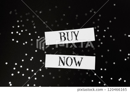 Buy now is written on a black background with stars Buy now is written on a black background with stars 120466165