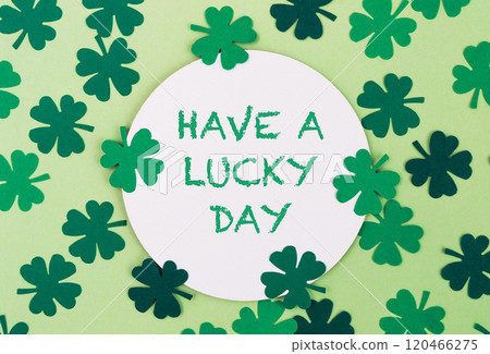 A green and white circle with four green clovers surrounding it A green and white circle with four green clovers surrounding it 120466275