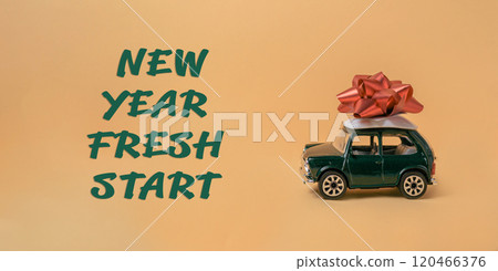 Green toy car with a red bow on top of it Green toy car with a red bow on top of it 120466376