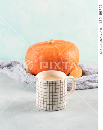Pumpkin spiced latte coffee on turquoise background with orange squash Pumpkin spiced latte coffee on turquoise background with orange squash 120466791