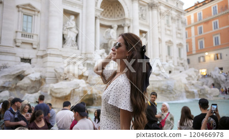 Trendy Tourist in white dress Smiling at Trevi Fountain in Rome, Italy  120466978