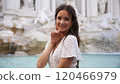 Smiling Woman in white Polka Dot Dress at Trevi Fountain, Rome  120466979