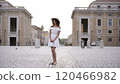Elegant Tourist by Iconic Fountain in Vatican City St. Peters Square  120466982