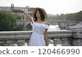Elegant Woman Overlooking the Tiber River and Historic Roman Architecture 120466990