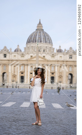 Graceful Woman in White Outfit Admiring St. Peter Square, Vatican City  120466992