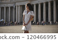Traveler in white dress enjoys the beauty of St. Peter Square, Vatican City  120466995