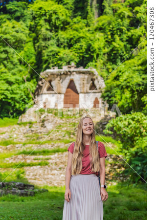 Female tourist exploring the ancient pyramids of Palenque, Mexico, surrounded by dense jungle. Cultural heritage and adventure travel concept 120467308