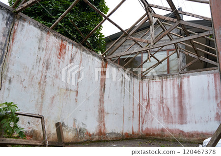 Walls from an abandoned old ruined house without a roof after a catastrophe. 120467378