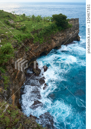 Cinematic aerial landscape shots of the beautiful island of Nusa Penida. Huge cliffs by the shoreline and hidden dream beaches with clear water and foaming wave. Cinematic aerial landscape shots of the beautiful island of Nusa Penida. Huge cliffs by the shoreline and hidden dream beaches with clear water and foaming wave. 120467381