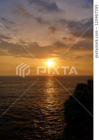 The view of the mountain and the ocean at sunset. A sunny path over the sea. The view of the mountain and the ocean at sunset. A sunny path over the sea. 120467395