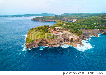 Cinematic aerial landscape shots of the beautiful island of Nusa Penida. Huge cliffs by the shoreline and hidden dream beaches with clear water. 120467427