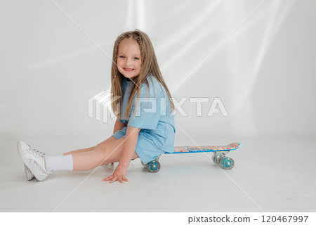 Funny little blonde kid girl 4-5 years old in casual clothes posing isolated on white background studio. Childhood lifestyle concept. Mock up copy space. Hold skateboard, Funny little blonde kid girl 4-5 years old in casual clothes posing isolated on white background studio. Childhood lifestyle concept. Mock up copy space. Hold skateboard, 120467997