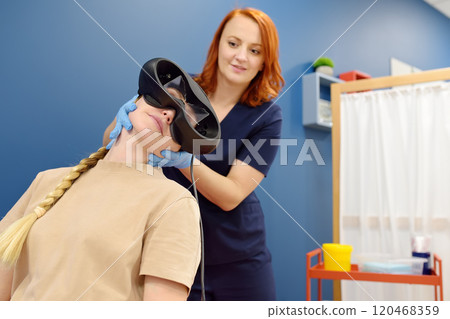 Neurologist performing positional testing of patient using videonystagmography . VNG testing uses goggles with infrared cameras to track eye movements, and can help to determine if the patient is Neurologist performing positional testing of patient using videonystagmography . VNG testing uses goggles with infrared cameras to track eye movements, and can help to determine if the patient is 120468359