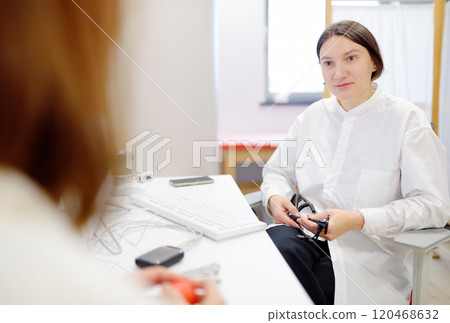 A cardiologist during appointment of patient. Doctor explains about deviations of heart work. Cardiology consultation and treatment A cardiologist during appointment of patient. Doctor explains about deviations of heart work. Cardiology consultation and treatment 120468632