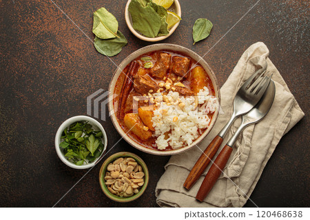 Delicious massaman curry with beef, potatoes, rice, and peanuts is served in bowl top view, Thai cuisine Delicious massaman curry with beef, potatoes, rice, and peanuts is served in bowl top view, Thai cuisine 120468638
