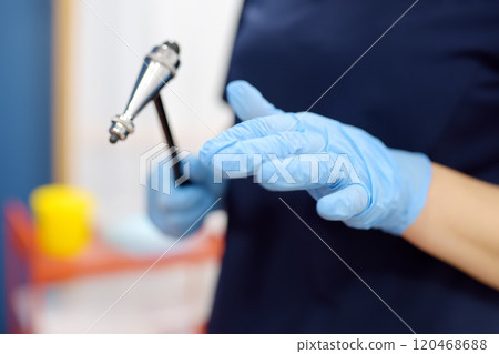 Doctor is checking the neurological reflexes of patient with hammer. Neurology professional doctor during work Doctor is checking the neurological reflexes of patient with hammer. Neurology professional doctor during work 120468688