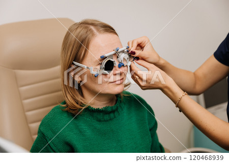 Optometrist fitting trial frames for precise vision testing and prescription determination 120468939