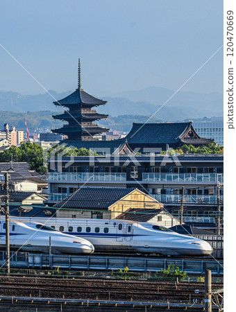 A magnificent view from the Kyoto Railway Museum of the elegant sister bullet trains with Toji Temple in the background A magnificent view from the Kyoto Railway Museum of the elegant sister bullet trains with Toji Temple in the background 120470669