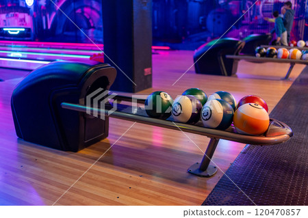 Modern bowling alley with ball rack and neon 120470857