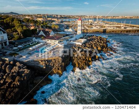 Aerial view of Santa Marta lighthouse and Cascais marina with Cascais cityscape Aerial view of Santa Marta lighthouse and Cascais marina with Cascais cityscape 120471404