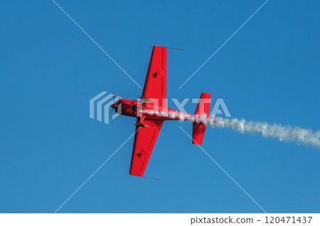 Stunt aerobatic plane performing stunts in air 120471437