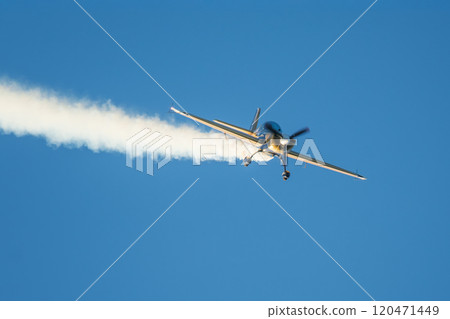 Stunt aerobatic plane performing stunts in air 120471449