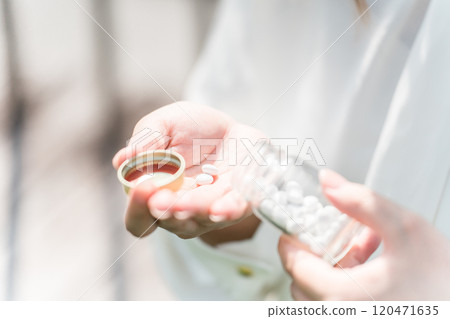 A young woman/business woman who takes medicine, supplements, and regular medicines 120471635