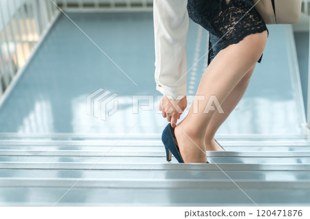 A business woman hurt her foot on the stairs (shoe blisters, swelling, injuries, blisters) A business woman hurt her foot on the stairs (shoe blisters, swelling, injuries, blisters) 120471876