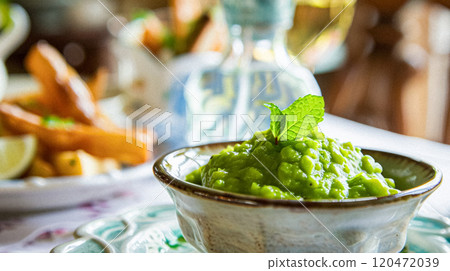 Mushy peas recipe, traditional English side dish for fish and chips, homemade cooking idea 120472039
