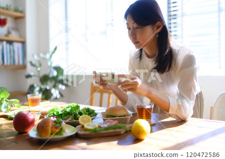A woman takes a picture of the amount with her smartphone A woman takes a picture of the amount with her smartphone 120472586