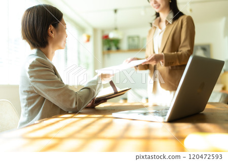Women showing materials Women showing materials 120472593