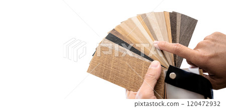 Designer hand pointing at sample of wood laminated material Designer hand pointing at sample of wood laminated material 120472932