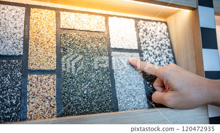 rchitect hand pointing at wash gravel texture on display shelf  120472935