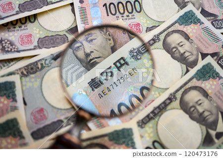 Money and magnifying glass 120473176