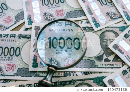 Money and magnifying glass 120473186