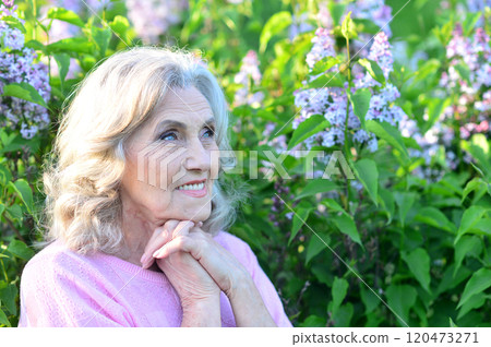 Portrait of a beautiful elderly woman in the park 120473271
