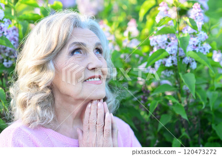 Portrait of a beautiful elderly woman in the park 120473272