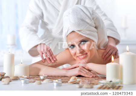 Beautiful woman in spa centar enjoying the massage. 120473343