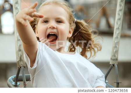 A Playful Child Happily Enjoying Various Outdoor A Playful Child Happily Enjoying Various Outdoor 120473656