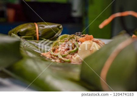 Closeup of raw ingredients for the elaboration of a Nicaraguan nacatamal. Nacatamal ingredients on banana leaves, Preparation of the traditional Nacatamal 120474183
